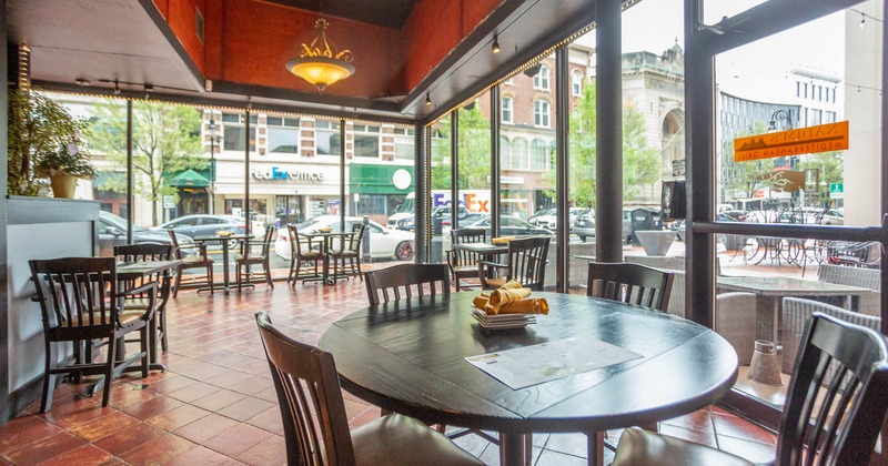 Interior, seating area, wooden tables and chairs, restaurant entrance, tile flooring