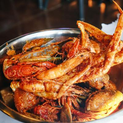 Cajun seafood boil served in a large metal bowl.