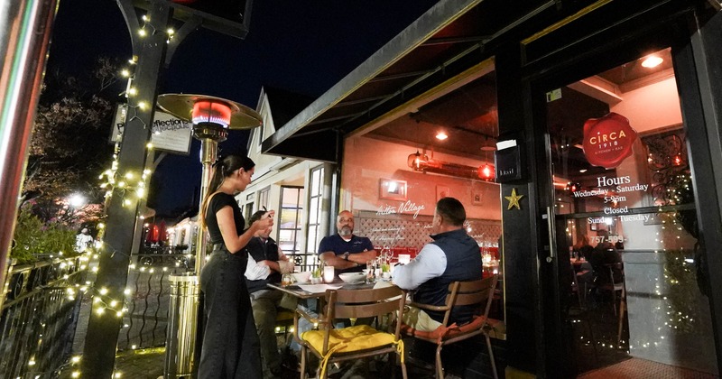 Exterior, side walk patio, table, chairs, guests