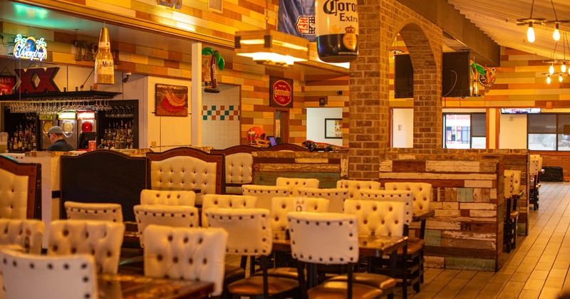 Interior, tables and chairs in dining area near the bar