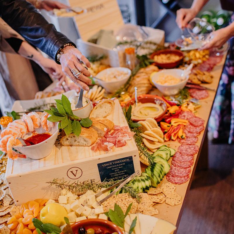 Guests browsing food items from the grazing table.