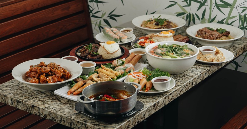Table filled with assorted dishes and sauces