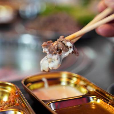 Dipping a piece of beef bulgogi