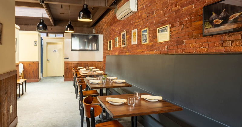 Dining banquette seating with tables and chairs, retro wall decorations