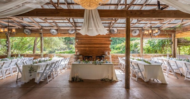 Wedding venue, white cloth tables, wedding decoration, exposed wooden beams