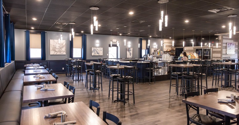 Interior dining area with long banquette seating and bar