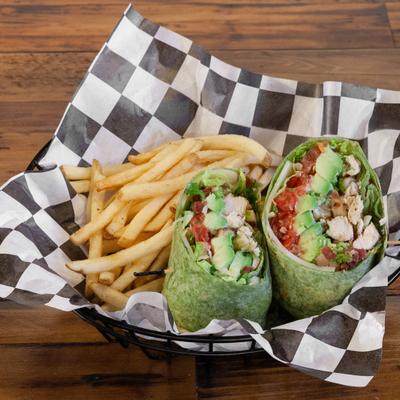 Chicken Wrap with tomato, bacon and avocado, in spinach flour tortilla, served with fries.