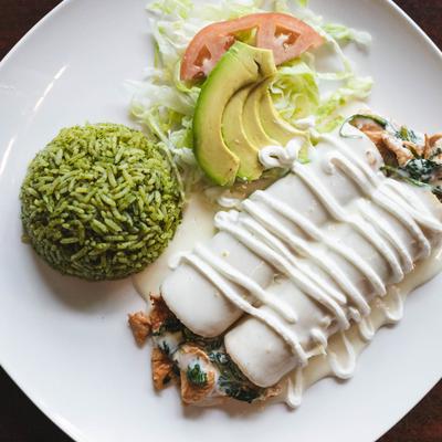 Enchiladas Margaritas served with poblano rice and avocado salad.