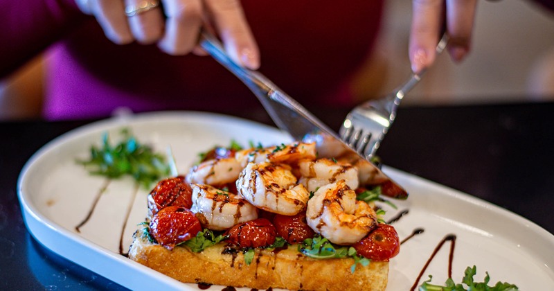 Shrimp toast being cutted on the plate