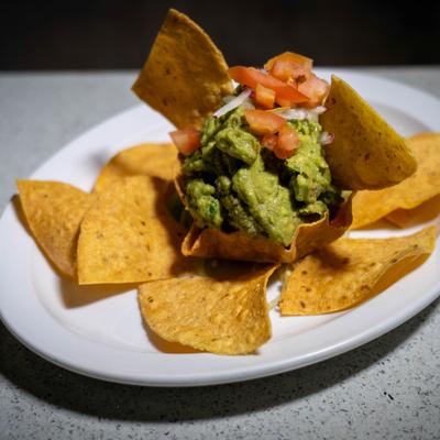 Guacamole served in tortilla bowl with chips.