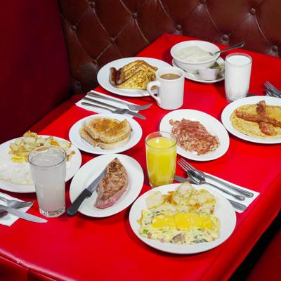 Various breakfast items served on the table with drinks.