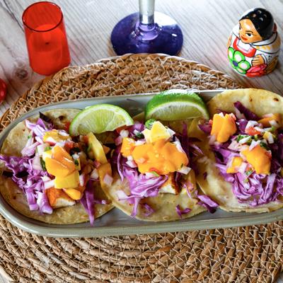 Grilled Mahi Mahi Tacos with topped with purple cabbage and mango salsa.