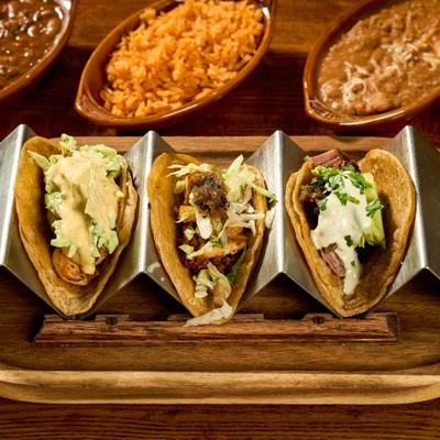 Breakfast Tacos served with rice and beans on the side.