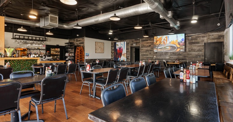 Interior, dining area, tables and chairs, ready for guests, long wooden banquette bench