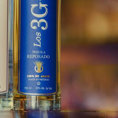 Aged tequila bottle with a blue label.