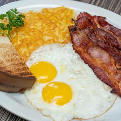 American breakfast of links, bacon, hash browns, eggs, and toast