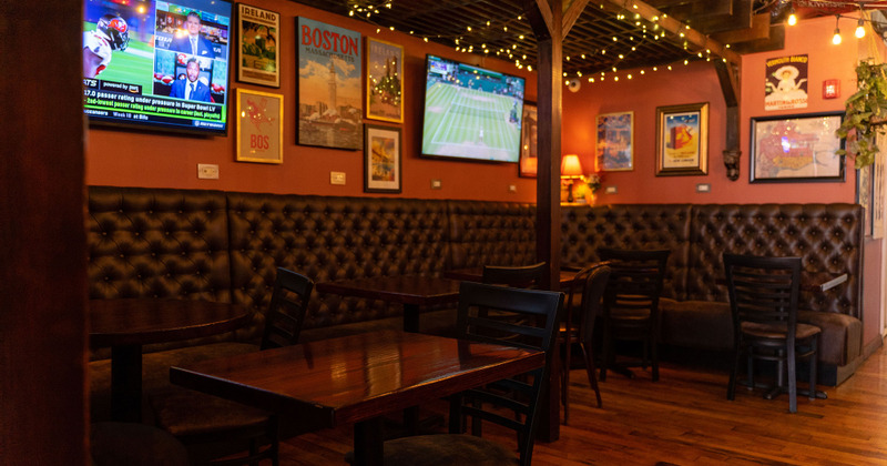 Restaurant interior, wooden tables and chairs, discreetly lit