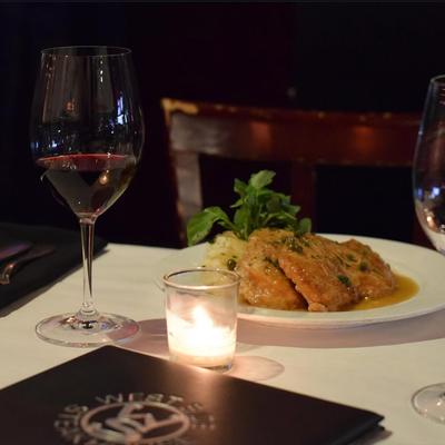 A served meal and red wine.