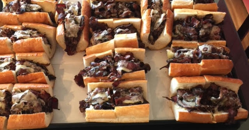 Hot pastrami sandwiches arranged on a tray
