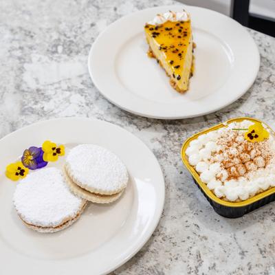 Assorted desserts arranged on white plates.