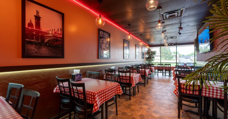 Interior seating area with tables with red and white checkered tablecloths