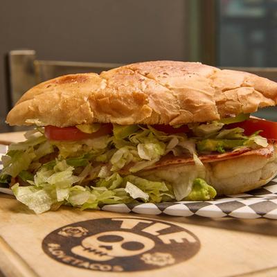 Mexican ham sandwich, with lettuce and toamtoes.