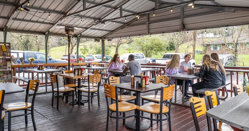 Covered patio, seating area, guests engaged  in conversation