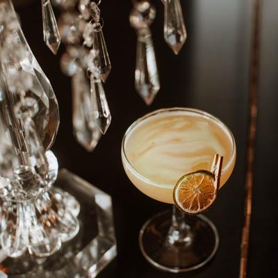 A cocktail in a glass, angled view