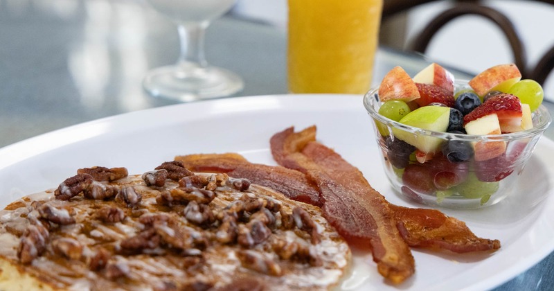 Cinnamon Pancake topped with pecans, served with bacon , and fresh fruit