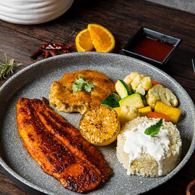 Butter fish plate with side rice and vegetables.