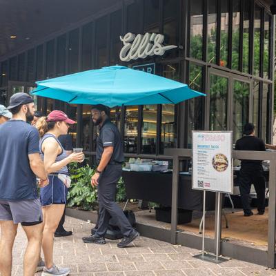 People gather outside the restaurant entrance.