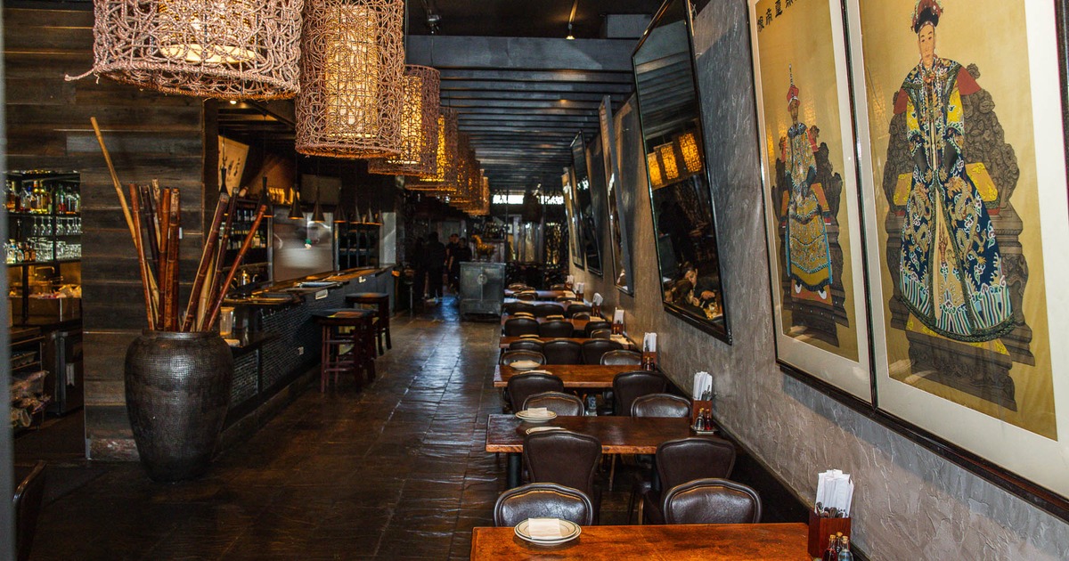 Interior, tables and chairs all lined up with bar on the left side