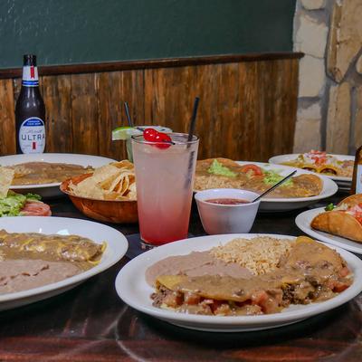 Mexican dishes and drinks on a table.