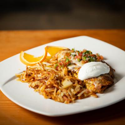Mexican omelet served with hash browns.