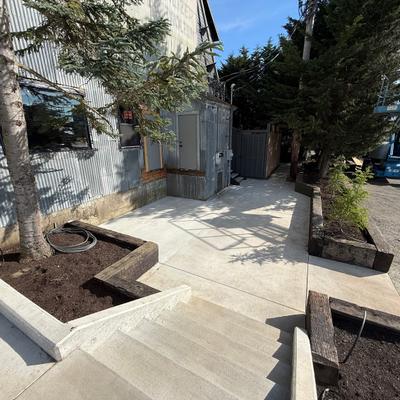 Exterior, backyard with a stamped concrete patio and elevated wooden planters.