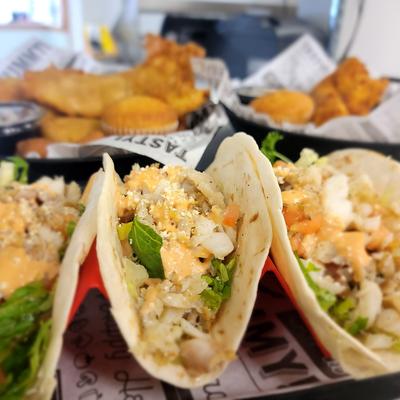 Fish tacos, with lettuce, pico de gallo, cotija cheese, and secret sauce.