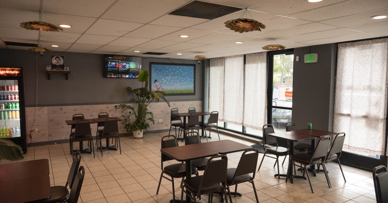 Interior, chairs and tables, big TV on the wall