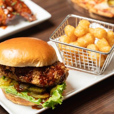 Hot honey chicken sandwich served with tater tots.