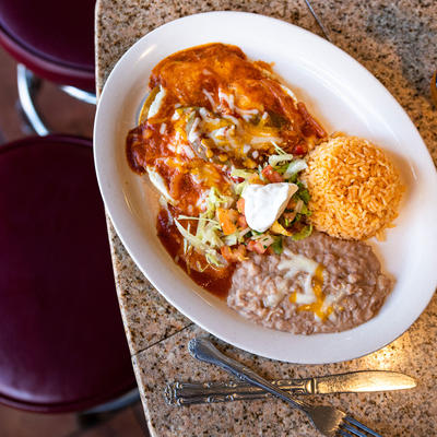 Rice, vegetables and cheese in sauce closeup