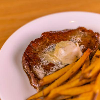 Painted Hills Strip Steak topped with marrow butter, served with fries