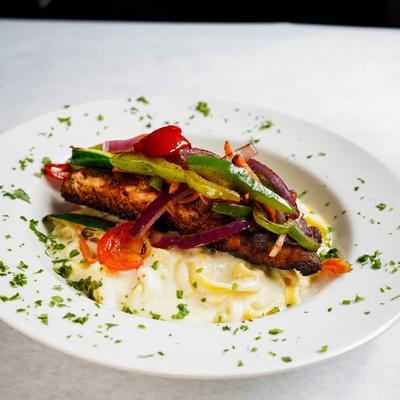 Blackened salmon fillet, julienne vegetables, fresh cut tagliatelle, alfredo.