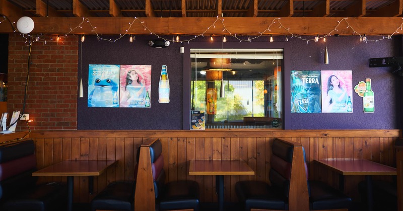 Interior, dining area, padded seating booths with wooden top tables, wooden details