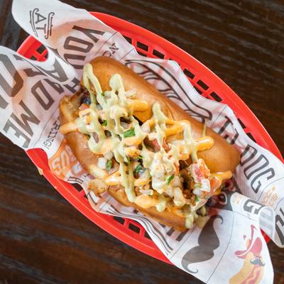 Bacon-wrapped hotdog, grilled onions, pico, chipotle, and guacamole crema
