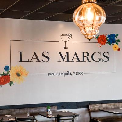 Interior, dining area, restaurant logo on the wall.