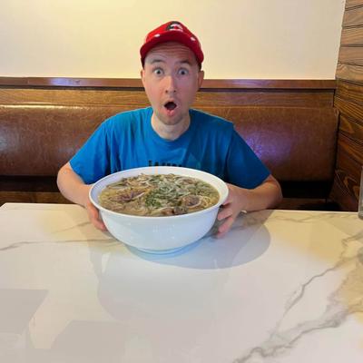 Guest holding a large bowl of soup.