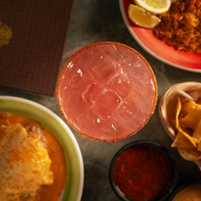 Overhead view of the Strawberry Margarita and various dishes.