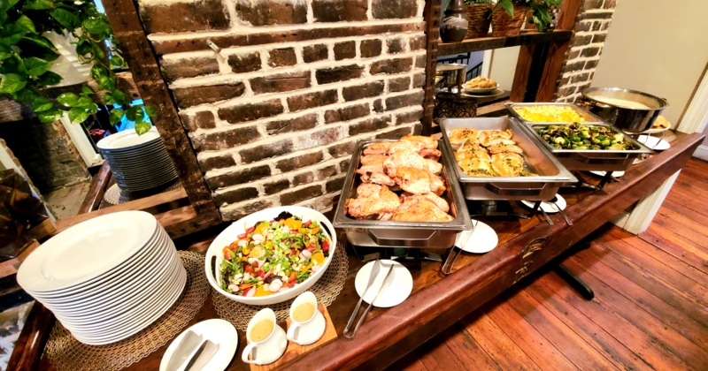 A buffet setup with food and plates
