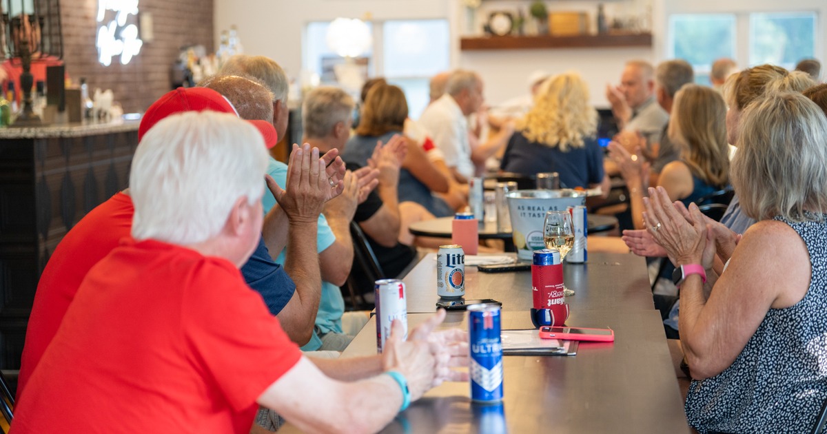 Bar table, people on party, fo;ow music perfomer