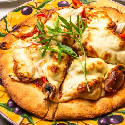 Spicy sausage pizza with mushrooms and red peppers.