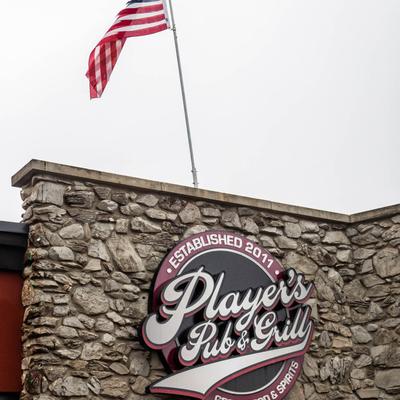Exterior, Pub's logo on the rock wall and a flag above it